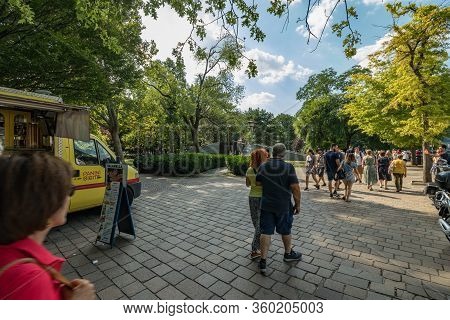 Como, Italy - August 4, 2019: Local People And Tourists On The Promenade Along The Lake In The Cente