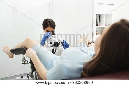 Colposcopy, Examination Of The Cervix. A Gynecologist Examines The Uterine Cavity Using A Colposcope
