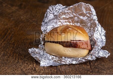 Bavarian Meat Loaf In A Bun On Wood