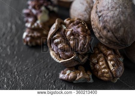 Halves Of The Kernel Of A Healthy Walnut Without Shell On A Dark Background, Walnut Macro Food Photo