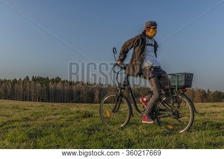 Young Man On Black Electric Bike In Spring Color Evening