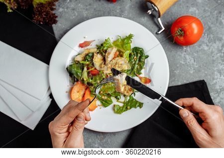 Caesar Salad With Chicken Eats Man. Photo From Above.