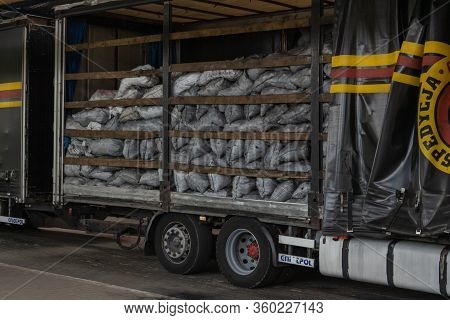 Krakovets, Ukraine - August, 2019: A Truck With A Trailer Loaded With Big Bags Of Charcoal, Located 