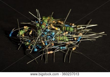 Many Small Through Hole Resistors Isolated On The Dark Background