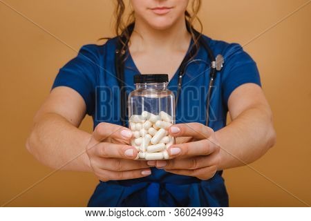 White Pills In A Female Doctor's Jar