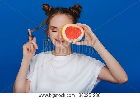 Surprised, The Laughing Girl Holds The Grapefruit Like Ears. Vegan Lifestyle. Smiling Woman , Eating