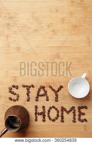 The Slogan Stay Home In The Form Of An Inscription Lined With Roasted Coffee Beans On A Warm Homemad