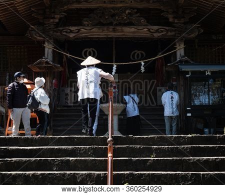 Kochi, Japan - April 7, 2018: O-henro Pilgrim Climbing The Stairs Leading To The Main Hall Of Kiyota