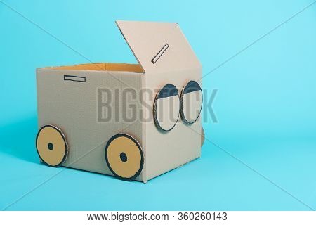 Car Creative By A Cardboard Box Imagination, Summer Holiday Travel Concept, Studio Shot On Blue Back