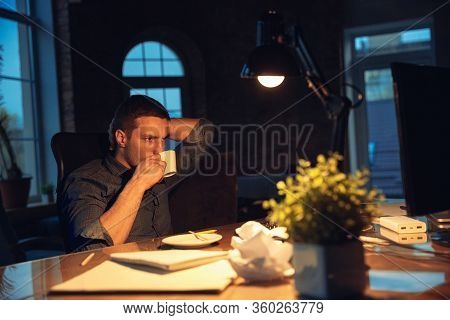 Coffee Rescues. Man Working In Office Alone During Coronavirus Or Covid-19 Quarantine, Staying To La