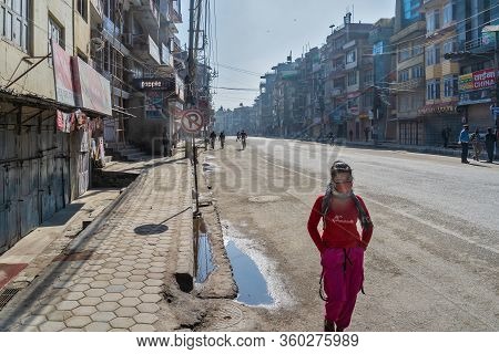 March 25, 2020. Kathmandu, Nepal. The ​​bouda Area. The Beautiful Nepali Girl In Red, Walk Against B