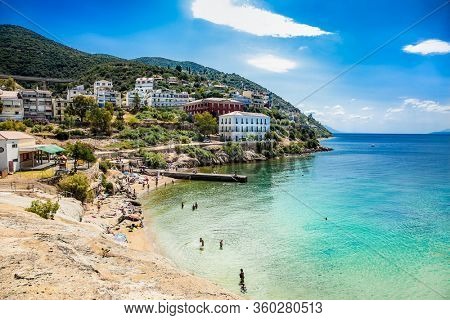 Loutra Edipsou, Evia, Greece- June,11 2018. Enjoying tourists in the warm medicinal spa water that springs from the rocks on the Aegean coast. Lutra Edipsou, Evia island, Greece