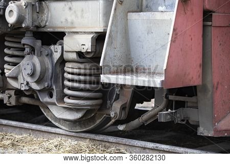 Low Angle View Of Wheel Mechanism Of Modern Train Locomotive On Tracks. Steampunk, Techno Concept. R