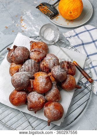 French Beignets With Powdered Sugar And Orange Zest.