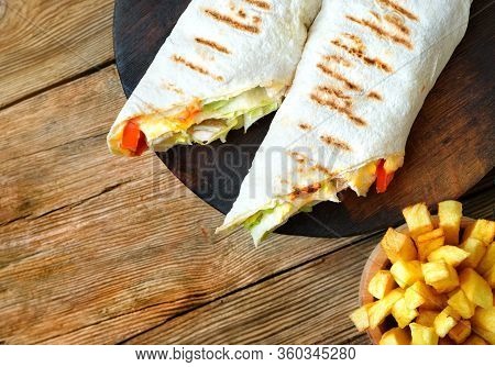 Shawarma And French Fries On The Wooden Table. Shawarma Sandwich Is A Most Popular Street Food In Th