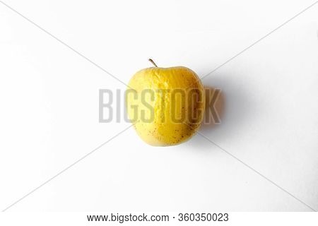 Old Yellow Apple On A White Background