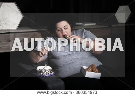 Depressed Overweight Woman Eating Sweets On Sofa At Night. Autophobia