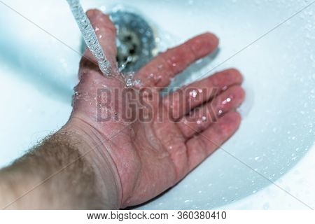 Male Hand. Hand Washing With Water In The Sink.