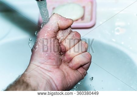 Male Hand. Hand Washing With Water In The Sink.