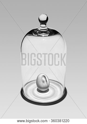 Orange Chicken Egg Protected Under A Glass Cover On A Light Background¸ Monochrome Photo