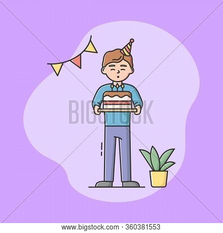 Children Birthday Party Celebration Concept. Birthday Boy Is Standing With Cake And Blowing Out Cand