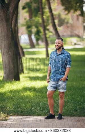 Young Guy Walking In The Spring Park. Sunny Day. Vesna.funny Guy. A Good Mood. Walking Portrait.