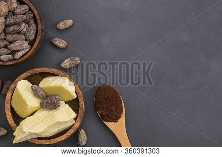 Cocoa Butter Or Cocoa Bean Solid Oil With Cacao Powder In Spoon And Raw Cocoa Beans In Wooden Bowl O