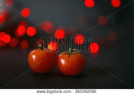 Two Ripe Tomatoes On A Black Background With Red Lights With Water Drops. Side. Fresh Village Produc