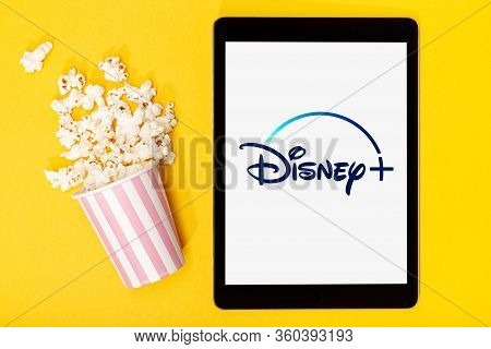 Galicia, Spain. March 9, 2020; Popcorn Bucket And Tablet With Disney Plus Logo On Yellow Background.