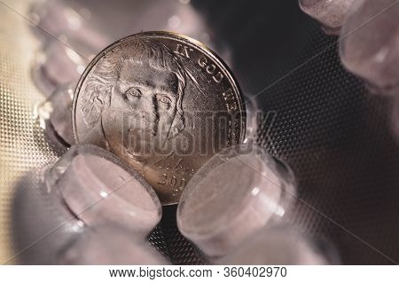Five Cent Coin On A Pack Of Pills