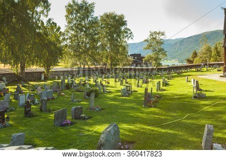 Lom, Norway - July 7, 2018: Graveyard With Old Tombstones Around Lom Stave Church In Oppland County,