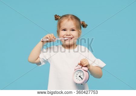 Oral Hygiene. Time To Brush Your Teeth. Little Child Girl Brushing Her Teeth With A Toothbrush And L
