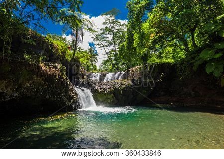 Vibrant Togitogiga falls with swimming hole on Upolu, Samoa Islands.