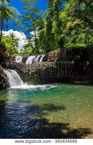 Vibrant Togitogiga falls with swimming hole on Upolu, Samoa Islands.