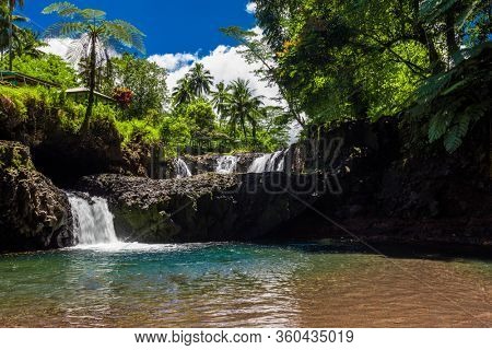 Vibrant Togitogiga falls with swimming hole on Upolu, Samoa Islands.