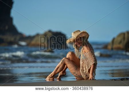 young woman relaxing on the beach in summer day