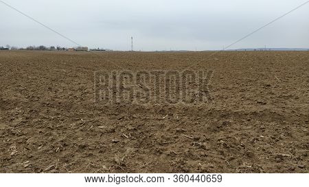 Oilcake Remaining After Harvesting Corn On The Ground. Clay, Furrows, Hay On The Field. Wet, Fertile