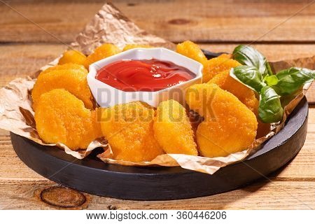 Chicken Nuggets And Ketchup Sauce On Black Burned Wooden Background Close Up.chicken Nuggets In Ketc
