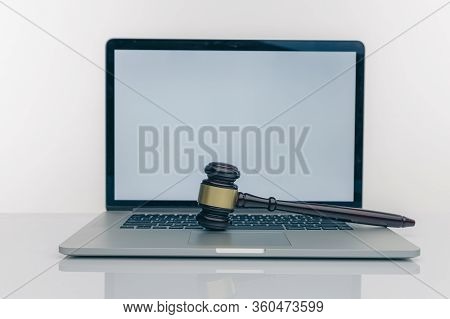 Workspace Of Lawyer With Laptop Blank White Screen And Law Wooden Gavel, Legal Book And Brass Scale 
