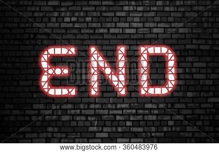 End Word Glowing In Pink Neon On A Dark Brick Wall Background. Ending Finish Concept Or Loss And Deb