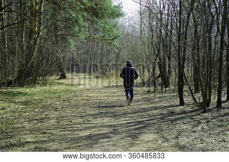 Athlete On A Run In A Beautiful Spring Forest.