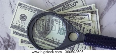 Pile Of American Dollars Money Under Manifying Glass