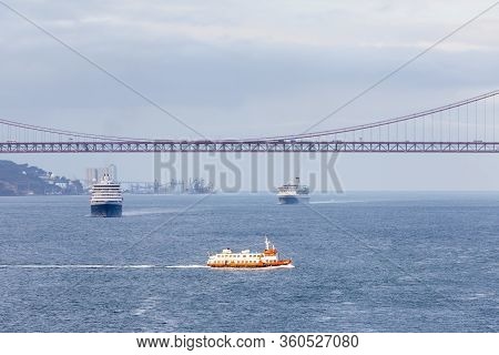 River Tagus.  Ships And Boats Traverse The River Tagus Beside The Port Of Lisbon In Portugal.