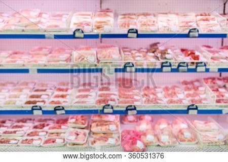 Display With Different Types Of Prepacked Meat In A Supermarket. Blur.