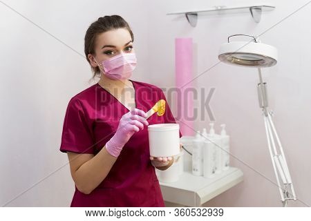 Portrait Of A Cosmetologist With Sugar Paste For Depilation. Shugaring. Sugar Paste Out Of The Conta