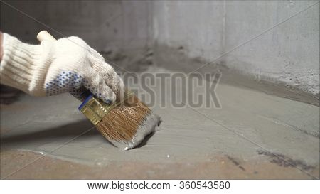 Workers Cover The Concrete Screed With Mortar And Make Waterproofing. The Process Of Waterproofing T