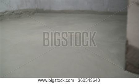 Workers Cover The Concrete Screed With Mortar And Make Waterproofing. The Process Of Waterproofing T