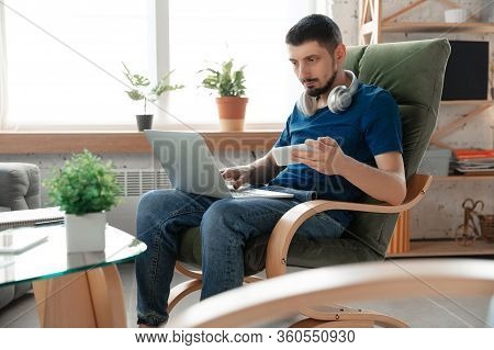 Young Focused Man Studying At Home During Online Courses Or Free Information By Hisself. Becomes Dri