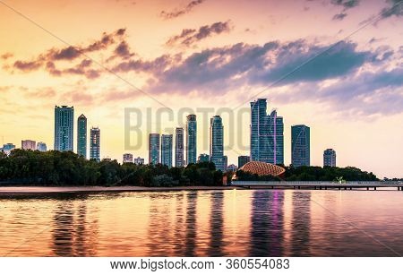 Sunset Over Emirate Of Sharjah Skyline In The Uinted Arab Emirates