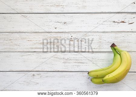 Bunch Of Green Bananas On White Wooden Background. Fruit Background